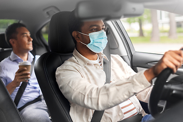 Image showing male passenger with coffee and car driver in mask