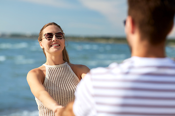 Image showing happy couple hugging on summer beach