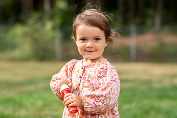 Image showing happy baby girl with soap bubble blower in summer