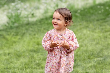 Image showing happy little baby girl outdoors in summer