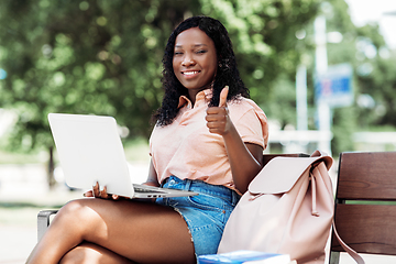 Image showing african student girl with laptop showing thumbs up