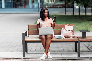 Image showing african student girl with laptop and smartphone