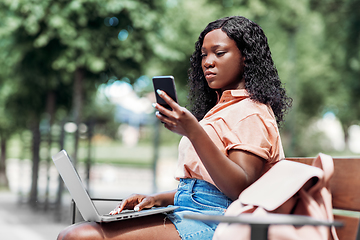 Image showing african student girl with laptop and smartphone