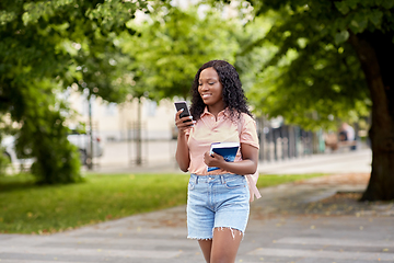 Image showing african student girl with smartphone in city