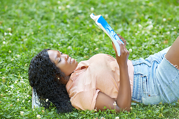 Image showing african student girl reading math textbook