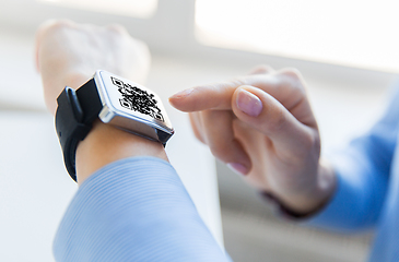 Image showing woman's hands with qr code on smart watch