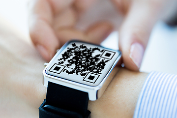 Image showing woman's hands with qr code on smart watch