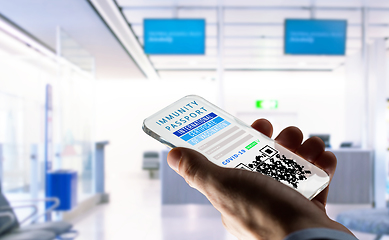 Image showing hand holding phone with certificate of vaccination