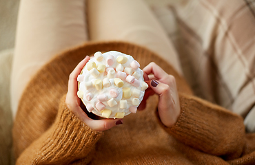 Image showing woman holding mug of marshmallow and whipped cream