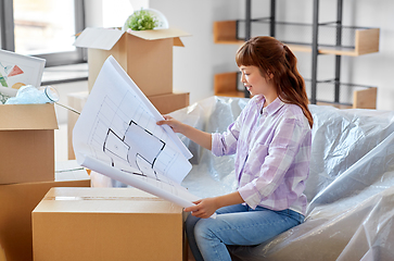 Image showing woman with blueprint and boxes moving to new home