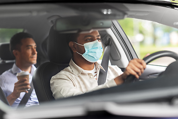 Image showing male driver in mask driving car with passenger