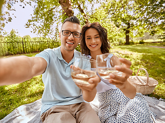 Image showing couple drinking wine and taking selfie at park