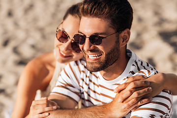 Image showing happy couple chilling on summer beach