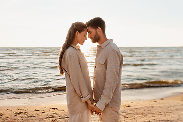 Image showing happy couple holding hands on summer beach