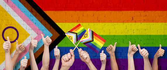 Image showing hands showing thumbs up over progress pride flag