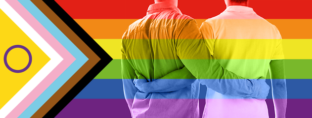 Image showing close up of male gay couple over pride flag