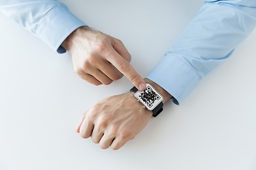 Image showing man's hands with qr code on smart watch