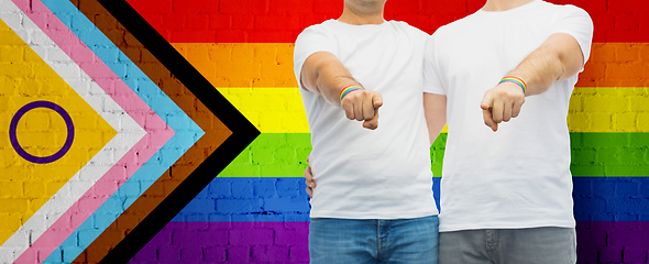 Image showing close up of male gay couple over pride flag