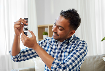 Image showing man showing smart watch with qr code on screen