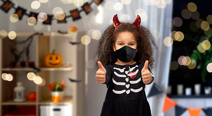 Image showing girl in black mask and halloween costume of devil