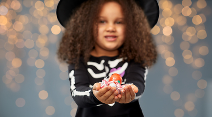 Image showing girl with candies trick-or-treating on halloween