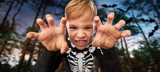 Image showing boy in halloween costume of skeleton making faces