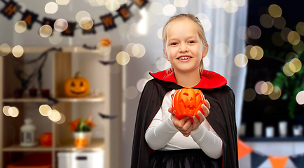 Image showing girl in halloween costume of dracula with pumpkin