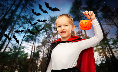 Image showing girl in halloween costume of dracula with pumpkin