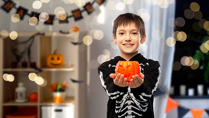 Image showing boy in halloween costume with jack-o-lantern