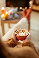 Image showing woman watches tv and drinks cocoa on halloween