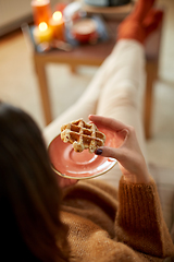 Image showing close up of woman eating waffle at home