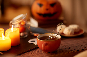 Image showing mesh tea infuser ball in ceramic mug on halloween