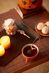 Image showing mesh tea infuser ball in ceramic mug on halloween