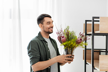 Image showing man decorating home with flower or houseplant
