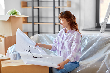 Image showing woman with blueprint and boxes moving to new home