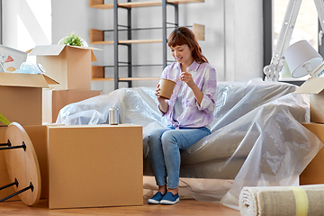 Image showing happy woman moving to new home and eating wok