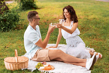 Image showing happy couple having picnic at summer park