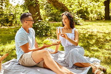 Image showing happy couple having picnic at summer park