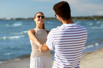 Image showing happy couple hugging on summer beach