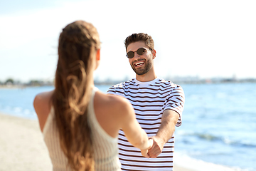 Image showing happy couple hugging on summer beach