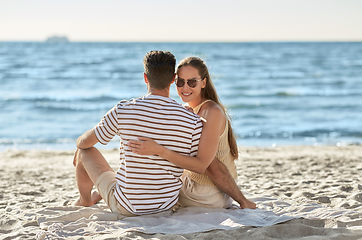 Image showing happy couple hugging on summer beach