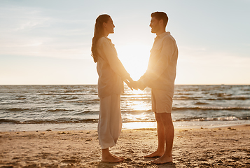 Image showing happy couple holding hands on summer beach