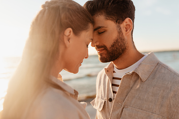 Image showing happy couple with closed eyes on summer beach