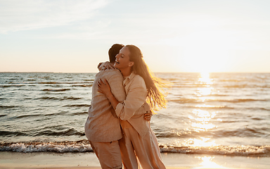 Image showing happy couple hugging on summer beach