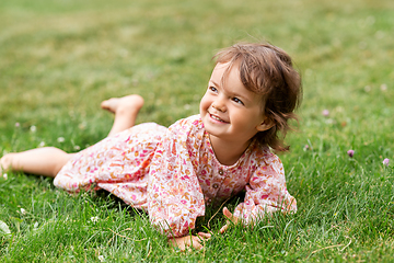 Image showing happy little baby girl lying on grass in summer