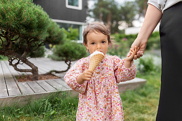 Image showing happy little baby girl eating ice cream