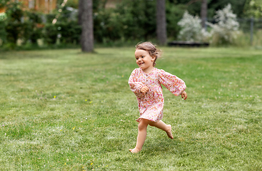 Image showing happy little baby girl running across summer field