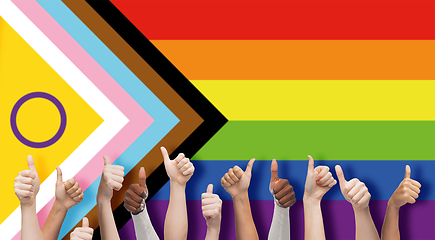 Image showing hands showing thumbs up over progress pride flag