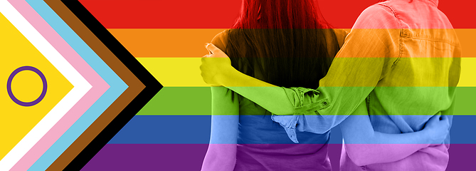 Image showing close up of female gay couple over pride flag