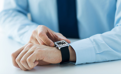 Image showing man's hands with qr code on smart watch